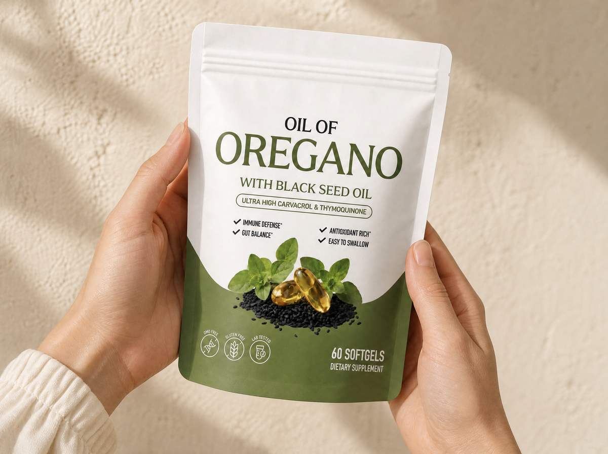 Hands holding the Oil of Oregano pouch against a warm wall